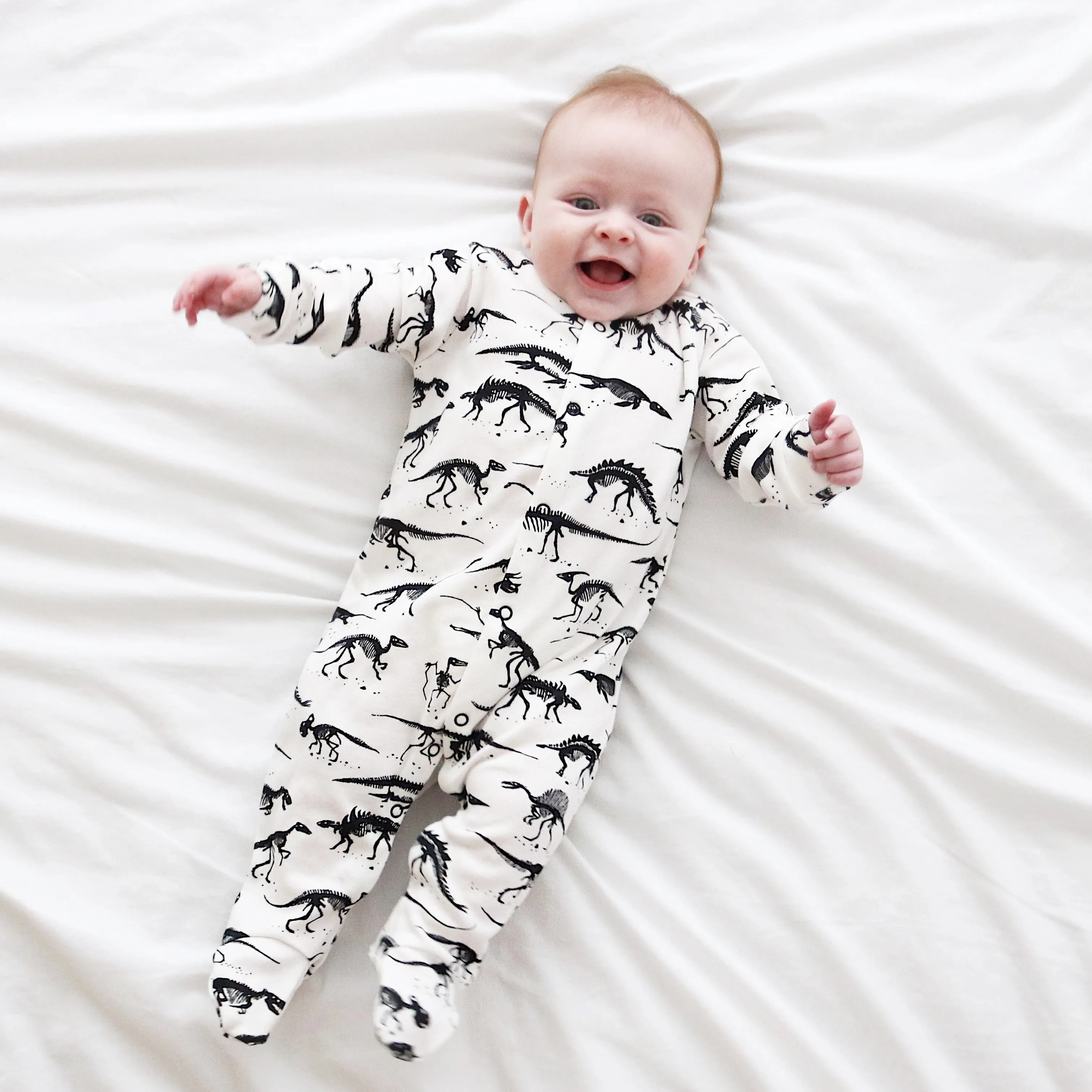 Milk Dino cotton sleepsuit